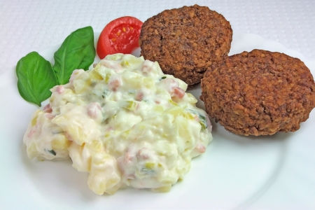 Meat Balls with Potato Salad, Tomato and Basil on Plate, close upの写真素材