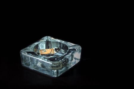 Cigarette End in an Ash Tray,  isolated on Black, close upの写真素材
