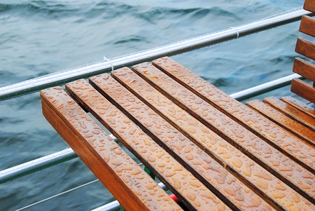 Raindrops on a Bench and Table on a Ships Deck の写真素材