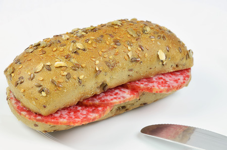 Salami Sandwich with Knife on white Plate, close upの写真素材