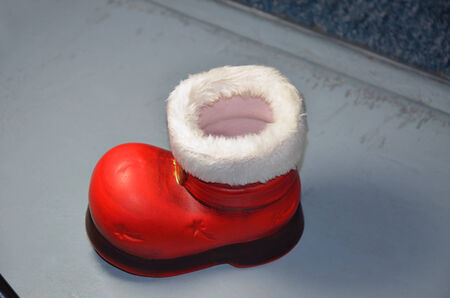 red santa boot, empty, close up, isolated on gray backgroundの写真素材