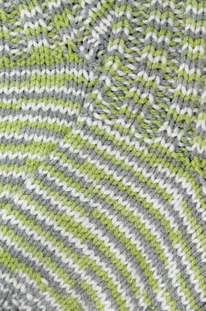 Close up of green gray, and white striped and flecked knitted socks, verticalの写真素材