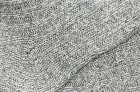 Close up of gray and white striped and flecked knitted socksの写真素材