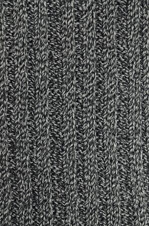 Close up of an anthracite, black and gray striped knitted shawl, verticalの写真素材