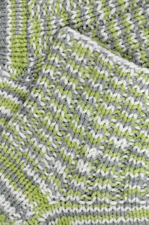 Close up of green gray, and white striped and flecked knitted socks, verticalの写真素材