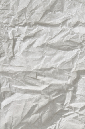 Close up of a creased, white, soft paper texture, full frame, close above, verticalの写真素材