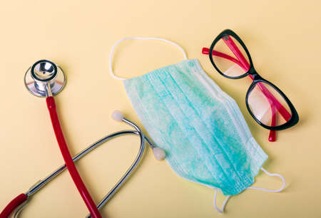 Medical face mask, stethoscope. Top view, covid - 19 protection concept. Medical equipment...