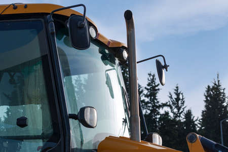 Part of the tractor, cabin, mirror in front, wipers and headlights. Exhausting pipe and windshield...