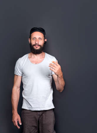 studio portrait of american handsome bearded man Surprised with bulging eyes. Positive emotions concept. Humorous photo of Russian Man smiling to camera, having pleased expression and cheerful lookの写真素材