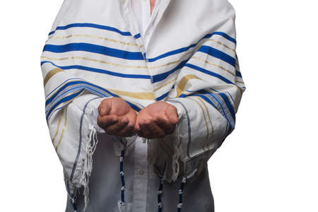 Religious Jew wrapped in a Tallit, prayer shawl with hands palms together receiving or giving gesture. hold and protection isolated on white background. Keeping hands, empty cupped palms togetherの写真素材