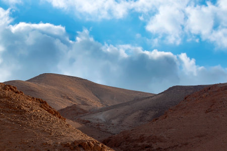 Shore, beach line of the Dead Sea, Israel. Mountain fantasy landscape on sky background with clouds. Sunny sky over salty cliffs, large salt mountains Sodom and Gomorrah. Judean desert, salt layersの写真素材