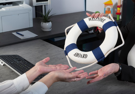 Women's hands with small lifebuoy. Woman holding lifebuoy travel concept. Life buoy ring in two female hands. lifeguard. insurance services for business. independent audit consultingの写真素材