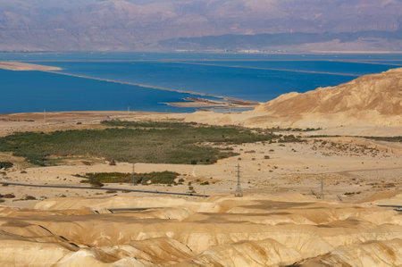 Dead sea salty shore. industrial sea salt landscape. Background with salty beach, salt water on coastline. Salt mining and extraction site in the middle of the Dead Sea of Israel. Desert, mountainsの写真素材