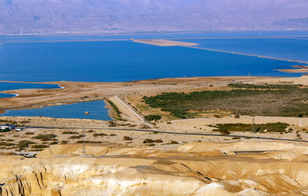 Dead sea salt shore. Sea coastline, Israel. Shore of Dead sea, Israel, white salt crystals outside and at the bottom, turquoise water. Jordan , panorama view of beautiful sea coast and beach of seaの写真素材