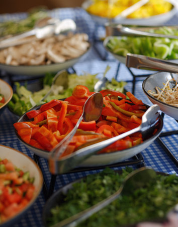 Red bell pepper in a bowl, selective focus. Spoons stir salad in glass plate, bulgarian peppers, party food mix on table. Vegetarian food, slimming diet. Sliced vegetable salad, iron spoon in a dishの写真素材