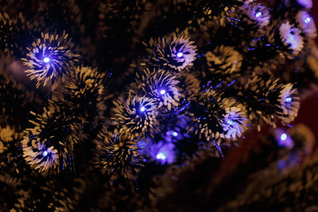 Christmas tree blue LED lights. Decorative tree branches decorated with garland lights. Bokeh in the background of branch, led, garlands. Xmas, New Year card. Snow Covered Artificial Christmas Treeの写真素材