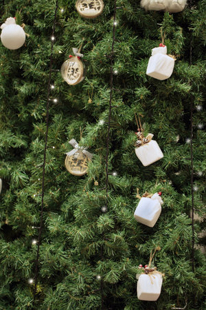Christmas tree decorated with lights and fir branches, copy space. Close up new year blurred background of balls with sparkle on christmas tree. Bokeh garlands in the background. New Year conceptの写真素材