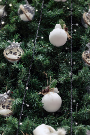 Close up new year blurred background of balls with sparkle on christmas tree. Bokeh garlands in the background. New Year concept. Christmas tree decorated with lights and fir branches, copy space.の写真素材
