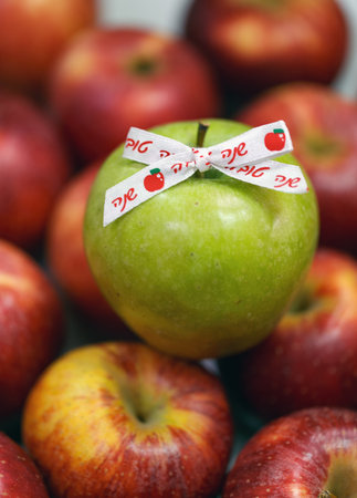 Group of red apples with one green apple in the center. Ribbon with the Hebrew inscription words shana tova is attached to it which means Happy New Year. Jewish holiday Rosh Hashanah Jerusalem, Israelの写真素材