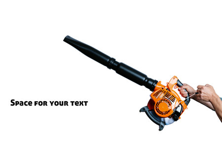 The gardener start a handheld, cordless, electric leaf blower isolated on white. Studio shot of male hands holding Engine pull cord a Air Blower Tool.の写真素材