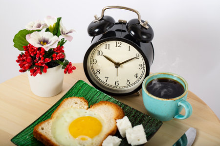 Breakfast on wooden cutting board isolated on white background with clipping path. Fried egg with...