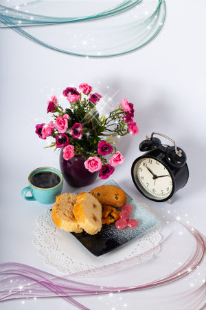 Breakfast composition with cup of black coffee with alarm clock, dessert and beautiful flowers in vase on a white background. Healthy food concept with copy space.の写真素材