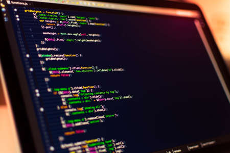 Software development. Software source code. Programming code. Writing code programming on laptop.の写真素材