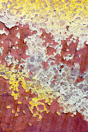 detail of crack on old wall color paint with red yellow 