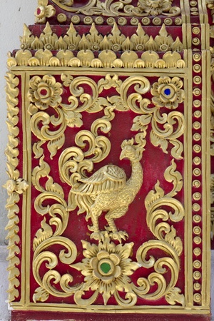 Texture of Stucco with animal symbol bird gold red colorの写真素材