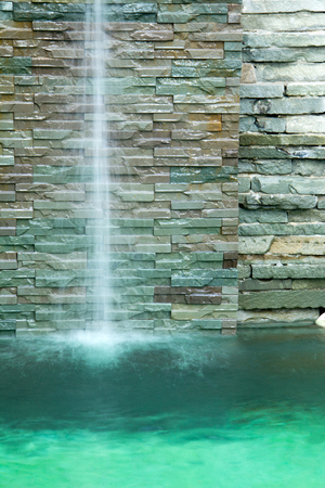 waterfall decorate in the pool and green water toneの写真素材