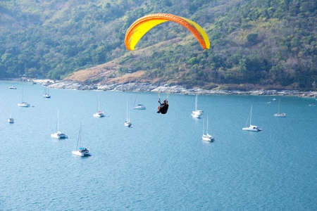 PHUKET, THAILAND-MARCH 9 :  A man paragliding sport over the sea of phuket island thailand in march 9, 2015のeditorial素材