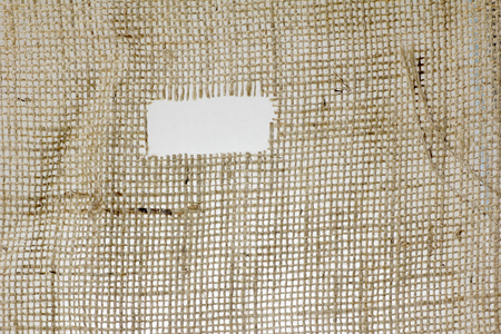 texture of Burlap hessian hole with frayed edges on white backgroundの写真素材