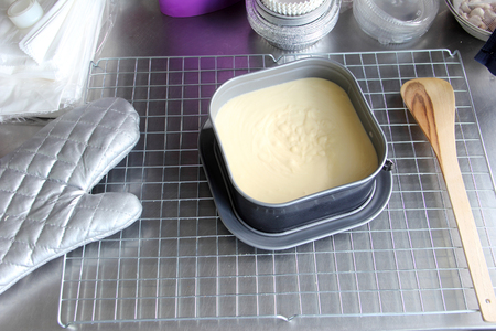 Bread flour mixed liquid in pan on wire rack prepared baking with hot protection glove .の写真素材