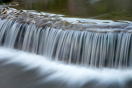 white waterfall from small river water fall over rock more copy space