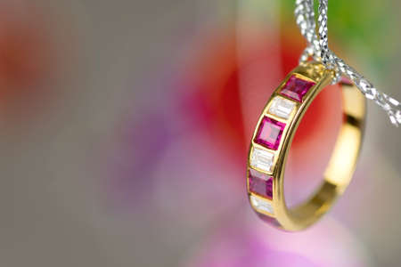 gold ring with square diamond ruby hang on silver threadの写真素材