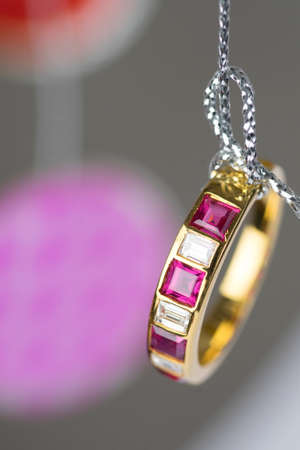 gold ring with square diamond ruby hang on silver threadの写真素材