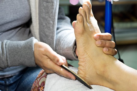 professional do manicure pedicure work on hand and footの写真素材