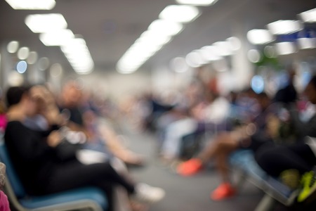Blur people sitting waiting in airport station terminalの写真素材