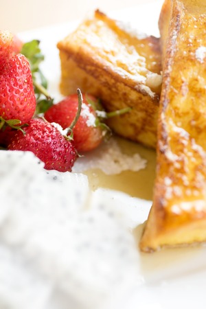 strawberry fantasy honey toast on square white dish wood tableの写真素材