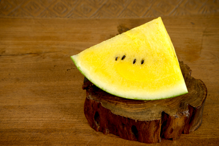 one piece of yellow water mellon on wood teakの写真素材