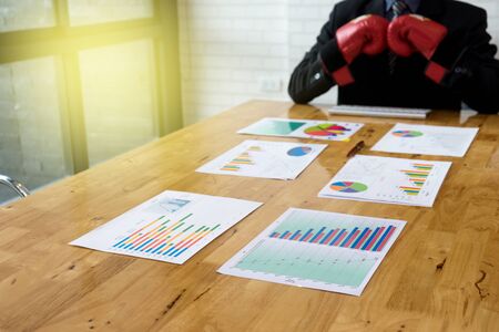 Business graph analysis working by power executive businessman fighter with red hand glove, vintage light styleの写真素材