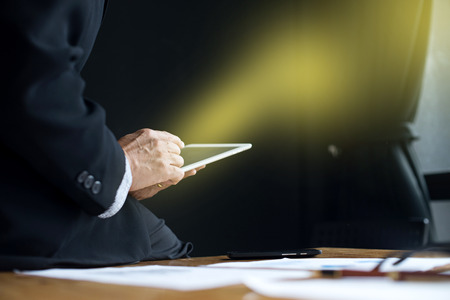 business man stand at the head of the table in boardroom black backgroundの写真素材