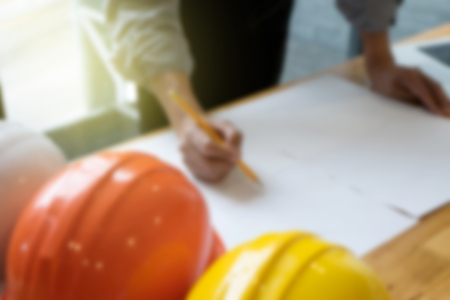 Blur Business man Architect or engineer drawing a project on the white paper.の写真素材