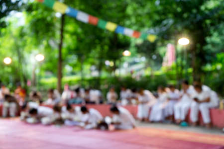 blur group of people white dress in green park and meditationの写真素材