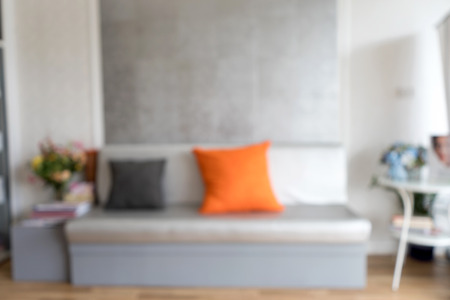 blur living room gray tone with orang color pillowの写真素材