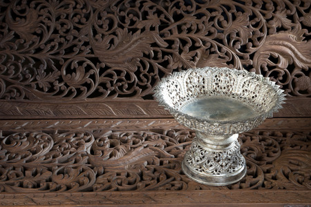 silver tray with pedestal Thai style on teak wood craftの写真素材