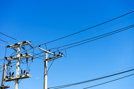 electrical wire on the  pole in the air with blue sky background and copy spaceの写真素材