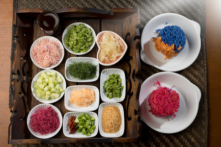 Thai Southern Spicy Rice Salad with Vegetables on dish and wood plate decorateの写真素材