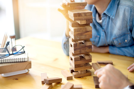 man and woman play wood material toy block for develop thinking and activity