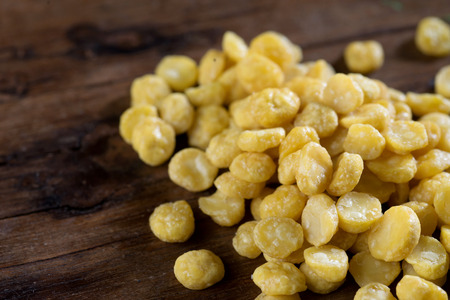 close up shot of yellow bean on wood background low key studio shotの写真素材